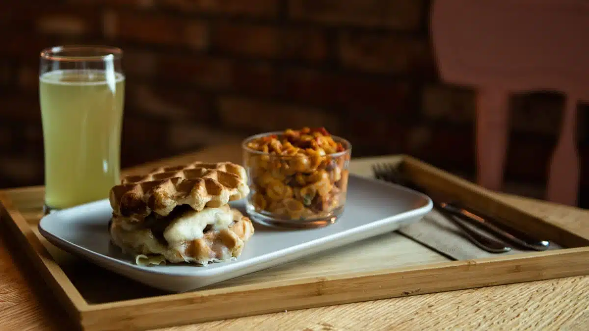 Sandwich dans des gauffres, salade de pâtes et verre de bière servis à l'Espace Saveurs